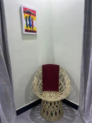a wicker chair with a towel on top of it at Upendo Moja House in Nkoanrua