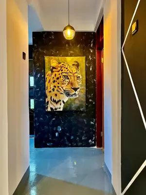 a painting of a tiger on a wall in a hallway at Fly Africa village 3 in Arusha