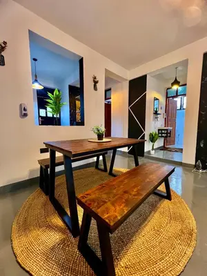a dining room with a wooden table and a bench at Fly Africa village 3 in Arusha