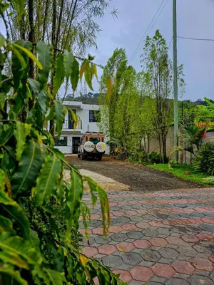 a house with a car parked in a driveway at Fly Africa village 3 in Arusha