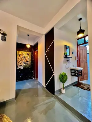 a hallway of a house with a door and a plant at Fly Africa village 3 in Arusha