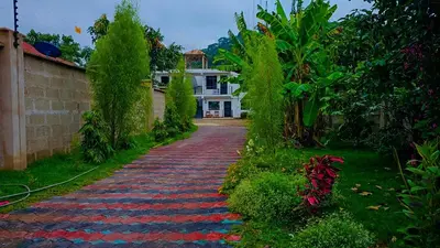 a cobblestone path in front of a house at Fly Africa village 3 in Arusha
