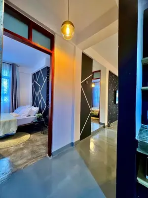 a room with a door leading to a bedroom at Fly Africa village 3 in Arusha