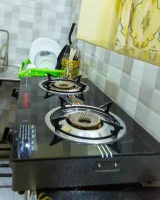 a stove top oven sitting on top of a kitchen counter at Lavish Homestay in Msaranga