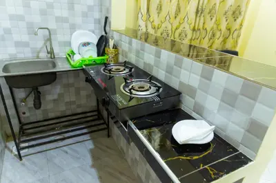 a small kitchen with a stove and a sink at Lavish Homestay in Msaranga