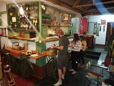 a group of people standing at a counter in a restaurant at I LOVE AFRICA VILLAs in Moshi