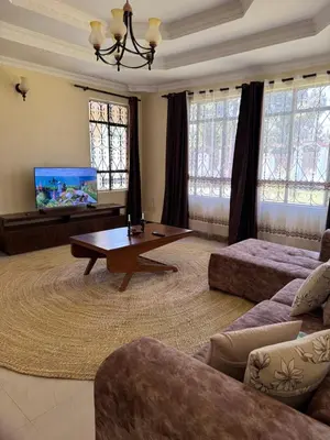 a living room with a couch and a coffee table at Maasai house in Arusha