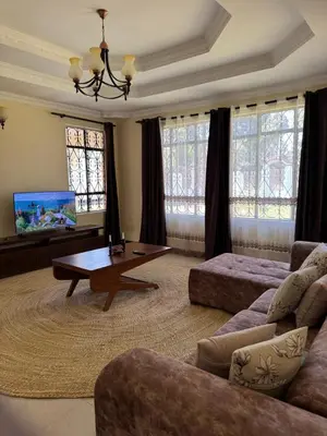 a living room with a couch and a coffee table at Maasai house in Arusha
