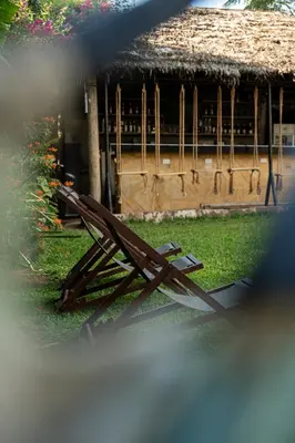 a wooden bench sitting in front of a building at White House Hostels - Arusha in Arusha