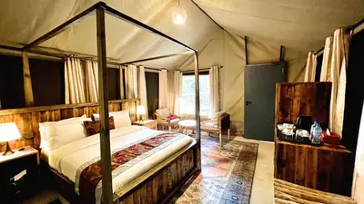 a bedroom with a canopy bed in a tent at Uyoga House in Arusha
