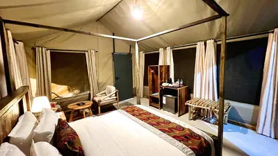 a bedroom with a canopy bed in a tent at Uyoga House in Arusha