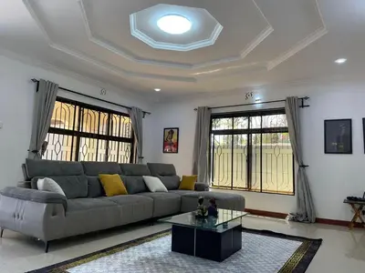 a living room with a couch and a table at Emmalanta Homes in Arusha