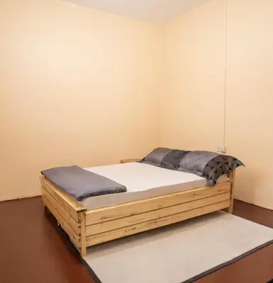 a bedroom with a wooden bed in a room at Bantulaki House in Arusha