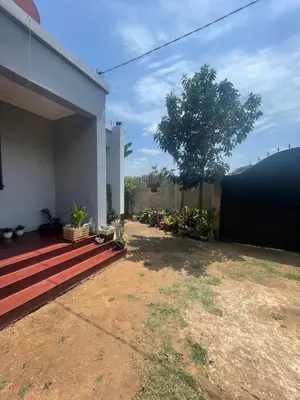a backyard of a house with a fence at Bantulaki House in Arusha