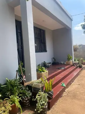 a porch of a house with plants on it at Bantulaki House in Arusha