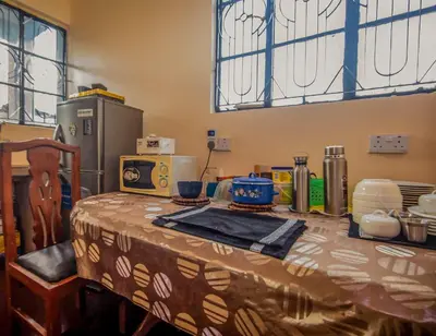 a table with a table cloth on it in a kitchen at Bantulaki House in Arusha