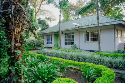 a house with a garden in front of it at Protea House in Marombosa