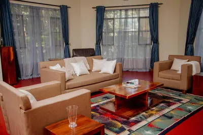 a living room with couches and a coffee table at Protea House in Marombosa