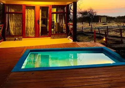 a swimming pool on a deck with a house at Furaha Luxury Lodge in Mto wa Mbu