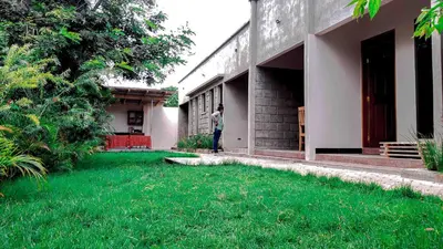 a man standing in the doorway of a building at Given House in Tuvaila