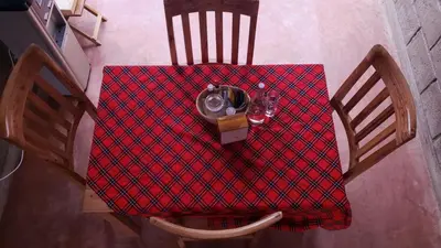 an overhead view of a table with a red table cloth at Given House in Tuvaila