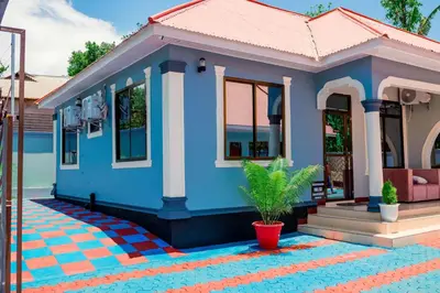 a small house with a blue at Avek Home Stay Ngorongoro Room in Uru