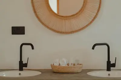 a bathroom with two sinks and a mirror at Foot On Africa Safari Lodge in Mto wa Mbu