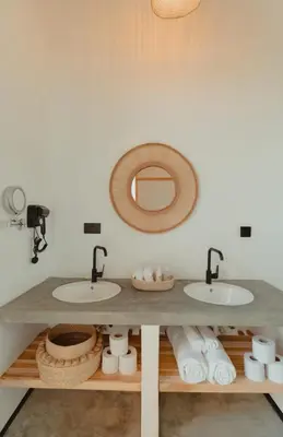 a bathroom with two sinks and a mirror at Foot On Africa Safari Lodge in Mto wa Mbu