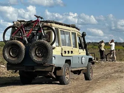 a jeep with a bike on the top of it at Namayana Camp in Makama