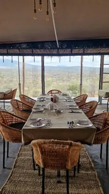 a dining room with a table and chairs at Namayana Camp in Makama
