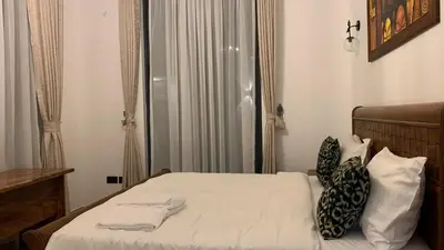 a bedroom with a bed with two towels on it at Casa Laurensana in Arusha