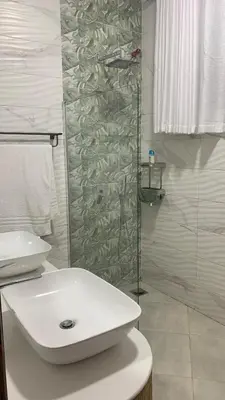 a bathroom with a white sink and a shower at Casa Laurensana in Arusha