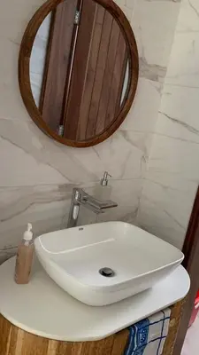 a bathroom with a white sink and a mirror at Casa Laurensana in Arusha