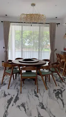 a dining room with a table and chairs at Casa Laurensana in Arusha