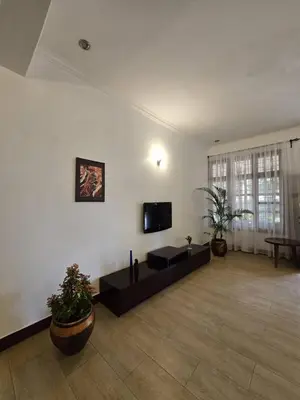 a large living room with a flat screen tv on the wall at Sprunger Retreat - tulia homes in Moshi