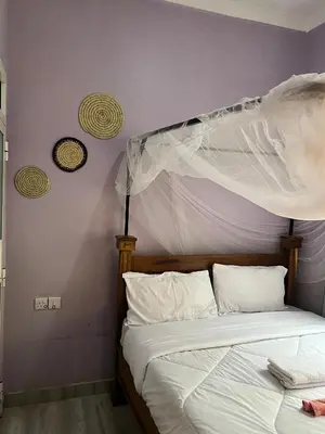 a bedroom with a bed with a canopy at Bushline Retreat in Karatu