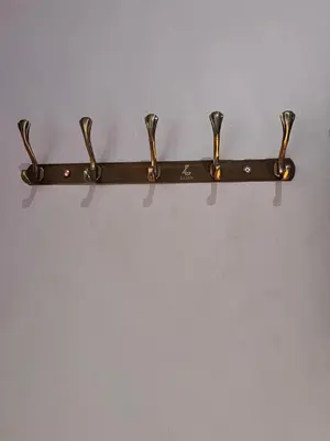a black towel rack hanging on a wall at Bushline Retreat in Karatu