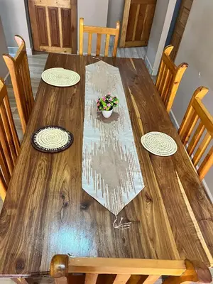 a wooden table with a potted plant on it at Bushline Retreat in Karatu