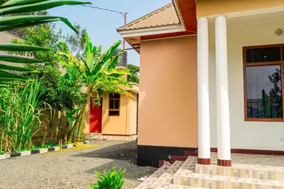 a house with white columns in front of it at Neylisa Apartments in Arusha