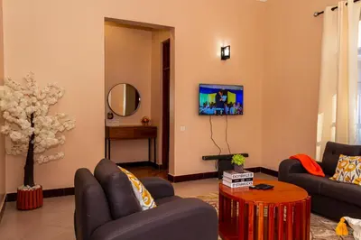 a living room with a couch and a table at Neylisa Apartments in Arusha