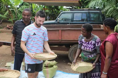 a group of people standing around a man holding baskets at Kinyaiya's Sereniry Farmstay