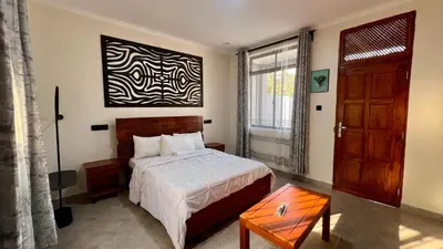 a bedroom with a bed and a large window at Domin Homestay in Arusha