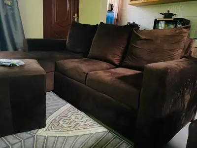 a brown leather couch in a living room at Blessings Home in Arusha