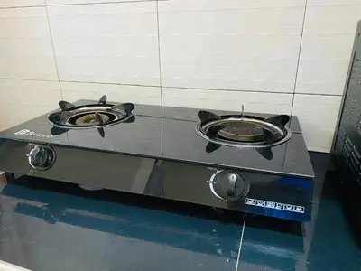 a stove with two frying pans on top of it at Blessings Home in Arusha