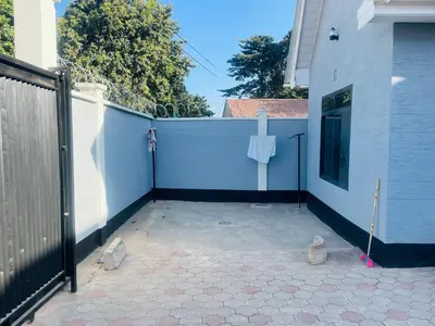 a patio with a white fence and a white fence at Blessings Home in Arusha