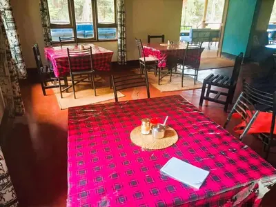 a dining room with a table with a red table cloth at Africa Sky Lodge, Bar and Restaurant in Karatu