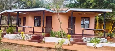 a house in the middle of a garden at Africa Sky Lodge, Bar and Restaurant in Karatu