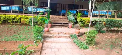 a walkway in front of a building with plants at Africa Sky Lodge, Bar and Restaurant in Karatu