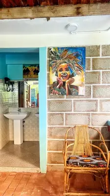 a painting on a brick wall next to a bench at Amoy River Lodge in Moshi