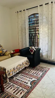 a living room with a couch and a rug at Amoy River Lodge in Moshi